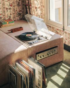 a bed with a record player on top of it at Les Suites Cinabre in Paris