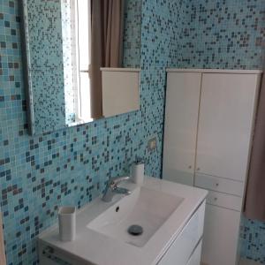 a bathroom with a sink and a mirror at Cà Delmo in Massa