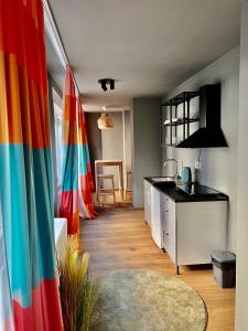 a kitchen with colorful flags in a room at Tulum Apart Center Belgrade in Belgrade