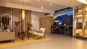 a living room with a couch and a table at Tucan Suites Tarapoto - Hotel Asociado Casa Andina in Tarapoto