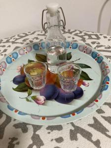 a plate with two glasses and a bottle on a table at Apartman K 99, Karadjordjeva 99, Bela Crkva in Bela Crkva +20 photos