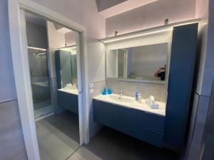 a bathroom with a sink and a mirror at Appartamento Pirandello in Lido di Camaiore