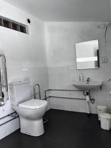 a white bathroom with a toilet and a sink at Glamping de Cerveira in Vila Nova de Cerveira