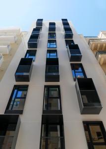 a tall white building with lots of windows at Eleven by Warren Collection in Sliema