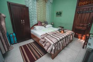 a bedroom with a bed with a blanket on it at Jesiwa B's Little Palace in Accra +77 photos
