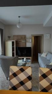a living room with a couch and a tv at Apartman Lucia in Bilice