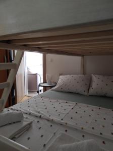 a bed in a room with a bunk bed at Apartman Lucia in Bilice