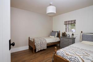 a bedroom with two beds and a window at Lovely home close to Killaloe and Lough Derg in Raheen Bridge