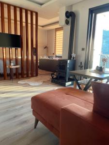 a living room with a couch and a table at Green Hill Apart in Ardeşen