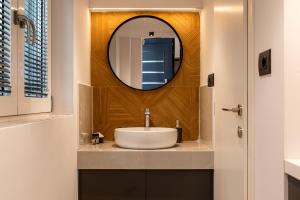 a bathroom with a sink and a mirror at DORADO ACCOMODATION in Heraklio