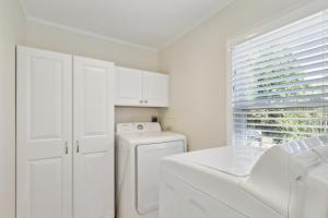 a white laundry room with a washer and dryer at Connecticut Retreat Steps to Historic Downtown! in Litchfield +16 photos
