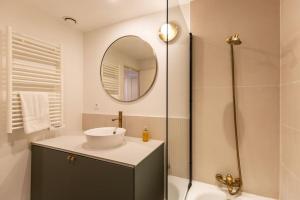 een badkamer met een wastafel en een spiegel bij La Belle Place in Honfleur +11 foto's