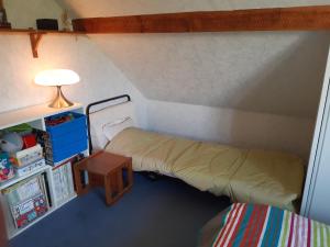 a small room with a bed and a table at Le petit chemin in Bougival