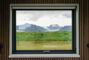 a window in a room with a view of mountains at HH Gisting/Guesthouse in Hólmur