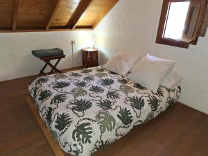 a bedroom with a bed with a black and white comforter at CASA RURAL CON PISCINA PRIVADA El ROBLE in Moya