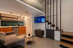 a living room with a couch and a kitchen at DORADO ACCOMODATION in Heraklio