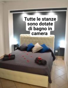 een slaapkamer met een bed met een bord aan de muur bij Villa longardi in Zafferana Etnea