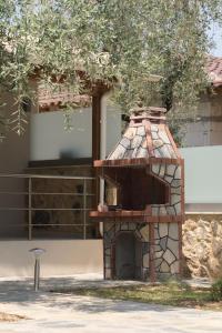 a brick oven in front of a building at LUXURY VILLAS ELENI STEFI in Limenas