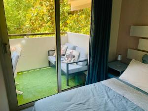 a bedroom with a balcony with a bed and a window at Butterfly-Palais des Festival-center-quiet-AC-Wi Fi parking in Cannes