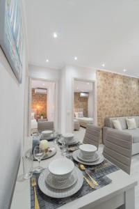 a living room with a table with plates and wine glasses at LUXURY VILLAS ELENI STEFI in Limenas