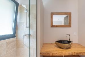 a bathroom with a sink and a shower at Logis Hôtel Les Vieilles Granges in Granges-Les-Beaumont