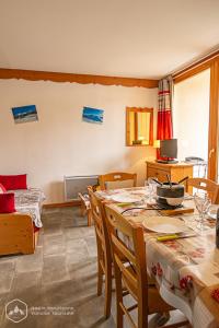 - un salon avec une table à manger et des chaises dans l'établissement Au refuge d'Hirka, à Termignon