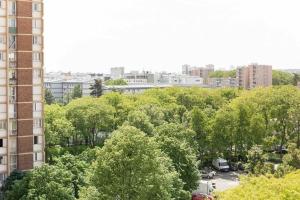 a view of a city with trees and buildings at Flat Design St Denis 4 personnes in Saint-Denis