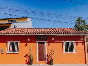 an orange house with a red roof at D'Ajuda Inn in Arraial d'Ajuda
