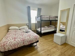 a bedroom with two bunk beds and a mirror at Granville Hotel in Blackpool