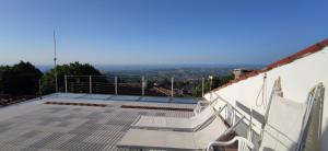 a balcony with stairs on top of a house at San Marino Skyline - Suite Olimpio in San Marino