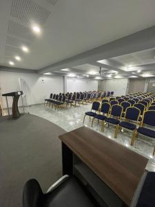 an empty room with blue chairs and a table at Gran Recreo Hotel - Trujillo - Perú in Trujillo