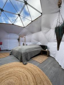 a bedroom with a large bed in a tent at Storjord Farmstay Glamping in Tromsø