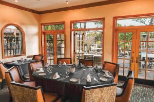 a dining room with a table and chairs and windows at Mission Resort and Club in Howey in the Hills