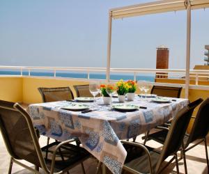 una mesa en un balcón con vistas al océano en Primera línea de mar con terraza ático en Magic World - Marina Dor, en Oropesa del Mar