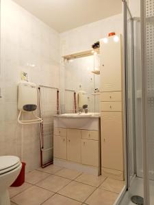 a bathroom with a toilet and a sink and a shower at la cigogne in Céret