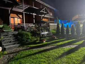 a yard with stairs and a house at night at Central Courtyard in Slavske
