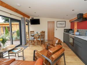 a kitchen and living room with a table and chairs at Pansi in Welshpool
