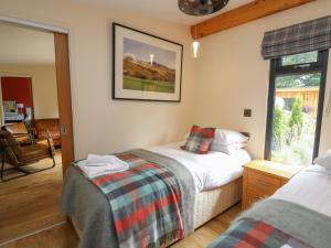 a bedroom with two beds and a window at Pansi in Welshpool