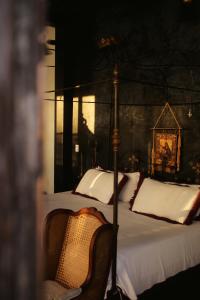 A bed or beds in a room at Coqui Coqui Casa de los Santos Izamal - THE ONLY ONE SUITE COLLECTION