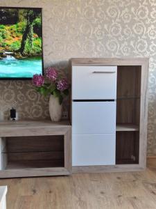 a white cabinet in a living room with a tv at Esperanto in Vranje