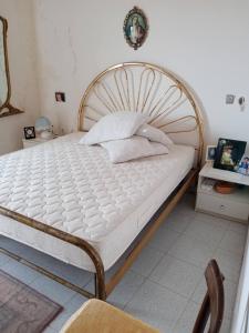 a bedroom with a large bed with a wooden frame at Casa della Nonna in Pizzo