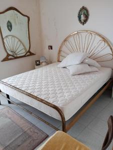 a bed in a bedroom with a white mattress at Casa della Nonna in Pizzo