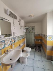 a bathroom with two sinks and a shower at Tuttiacasaditeresa Rooms in Procida