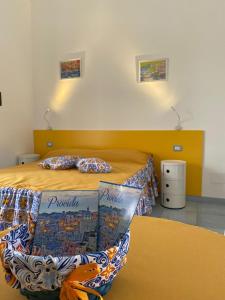 ein Schlafzimmer mit einem Bett mit zwei Kissen und einem Tisch in der Unterkunft Tuttiacasaditeresa Rooms in Procida