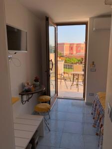 a room with a balcony with a view of a patio at Tuttiacasaditeresa Rooms in Procida
