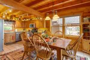 a kitchen and dining room with a wooden table and chairs at Lakefront Langley Retreat with Decks and Great Views! in Spavinaw