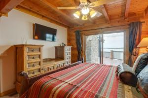 a bedroom with a bed and a sliding glass door at Lakefront Langley Retreat with Decks and Great Views! in Spavinaw