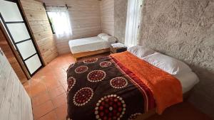En eller flere senge i et værelse på Cabañas Tepani