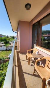 a balcony with two chairs and a table at Kazak in Obzor