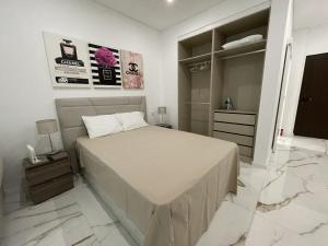 a bedroom with a bed and a walk in closet at Estudio Balaia by Villas Key in Albufeira